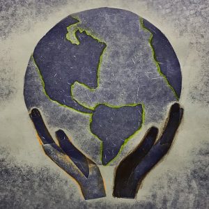 A pressure print created by a 7th grade student showing a pair of hands holding up the Earth.
