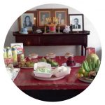 Lydia's family table, set with delicious food and photos of her ancestors.