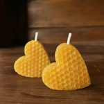 Two small yellow heart-shaped honeycomb beeswax candles