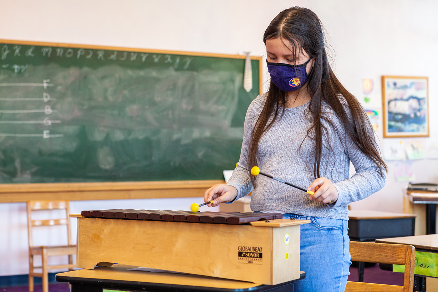 A 4th grade student learns to play the xylophone