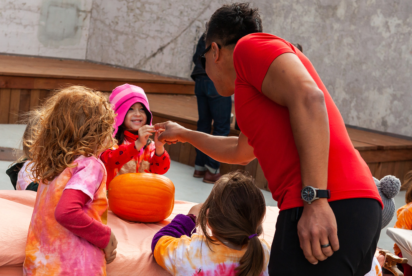 Kindergarten Teacher Carlos Rodriguez plays with one of his young students, who is smiling gleefully