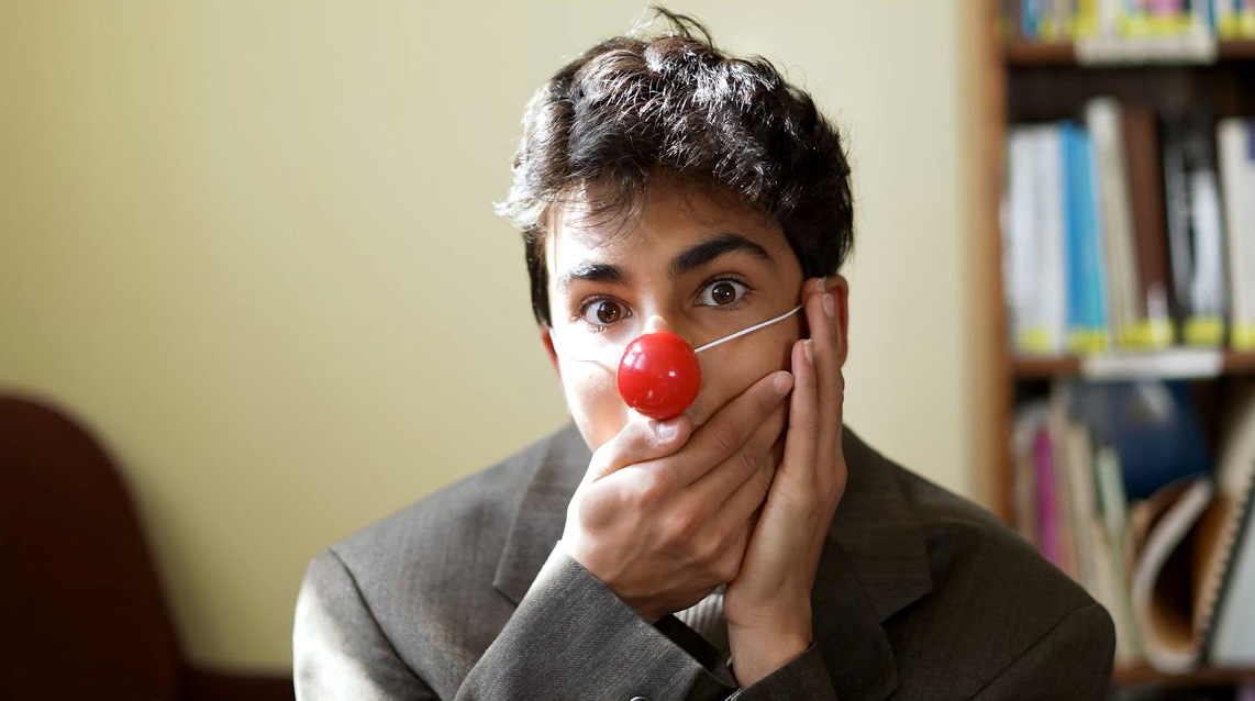 A CLWS 8th grade student poses with his clown nose on