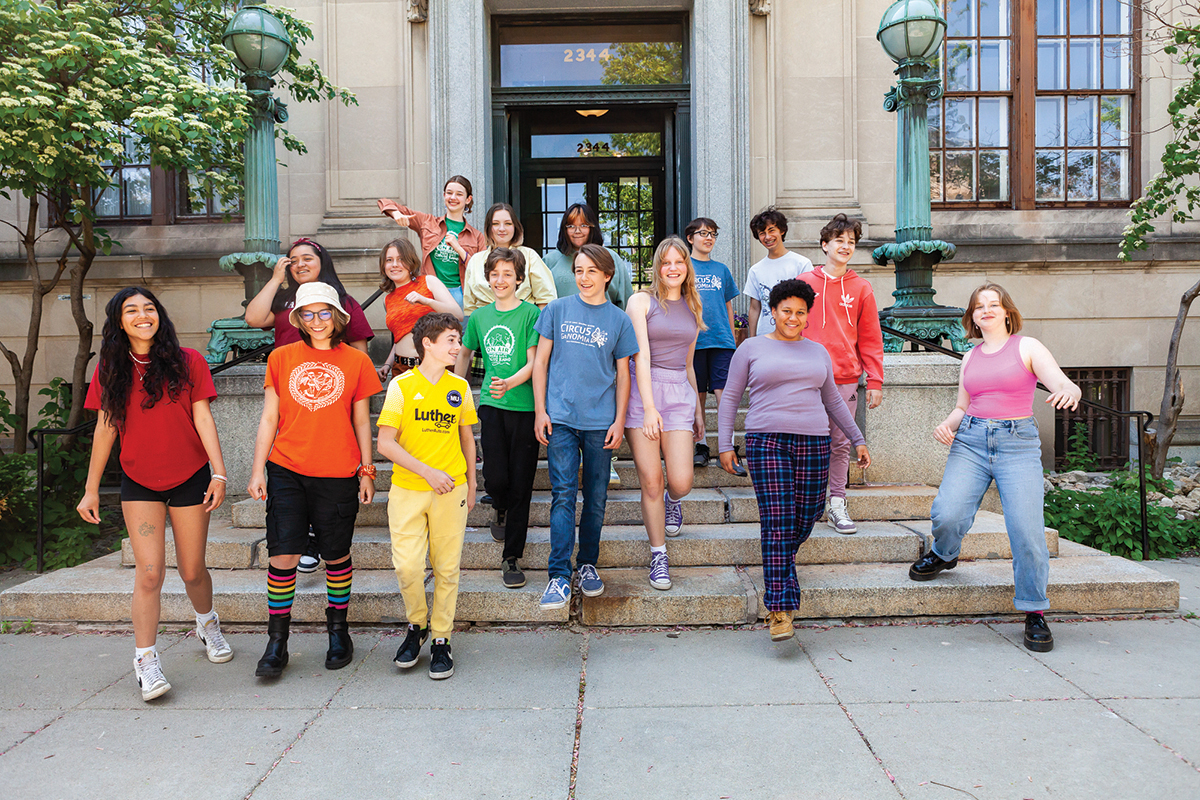 The 8th grade class walks down the front steps of the building, big smiles shining bright, ready to head out into the world!